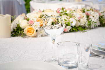Wedding banquet tables preparing for a wedding outside on a summer day