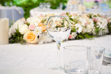 Wedding banquet tables preparing for a wedding outside on a summer day