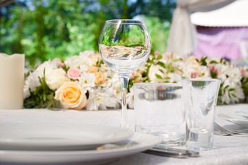 Wedding banquet tables preparing for a wedding outside on a summer day