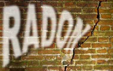A cracked brick wall with radon gas escaping - concept image with copy space