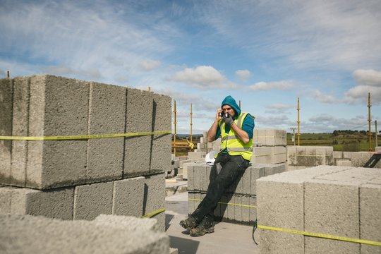 Engineer drinking coffee and talking on the phone