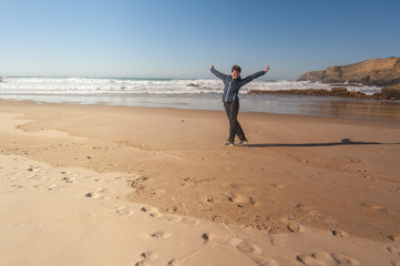 The girl on the Atlantic ocean beach, happy, Portugal