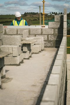 Engineer doing a level check on the wall