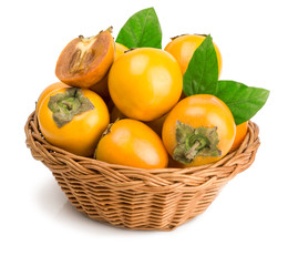 persimmons in basket on white background
