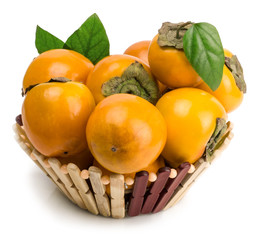 persimmons in basket on white background