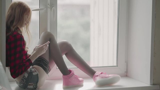 Young girl hipster in checkered shirt shorts and pantyhose