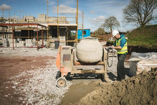 Engineer Mixing Cement In Concrete Mixer