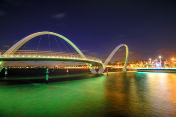 Elizabeth Quay Bridge by night on Swan River at entrance of Elizabeth Quay marina. The arched...