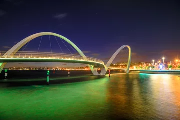 Fotobehang Elizabeth Quay Bridge by night on Swan River at entrance of Elizabeth Quay marina. The arched pedestrian bridge is a tourist attraction in Perth, Western Australia. Copy space. © bennymarty