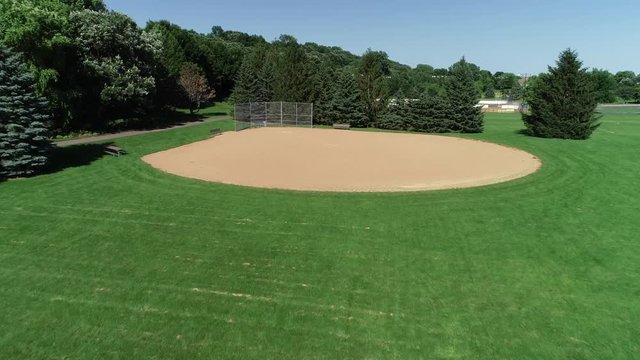 Drone aerial shot of an empty kids baseball diamond field at a park. Prores file, shot in 4K.