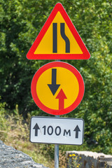 Temporary road sign on roadside, close up / Country road with temporary road signs, close up
