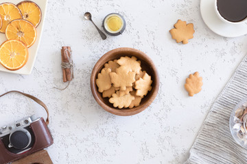 Top view of honey cookies in the shape of maple leaf on vintage autumn background, flat lay.