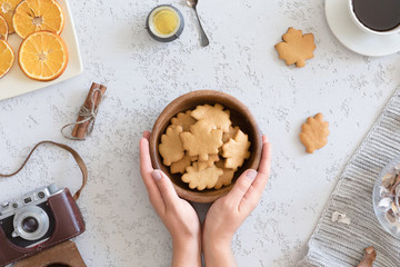 Top view of honey cookies in the shape of maple leaf on vintage autumn background, flat lay.