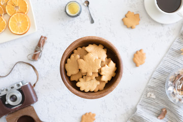 Flat lay of cozy autumn breakfast with homemade honey cookies and cup of tea, top view