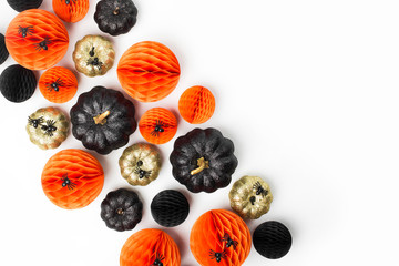 Shiny Decorative Pumpkins and Honeycomb balls. Halloween decorations. Flat lay, top view trendy holiday concept.