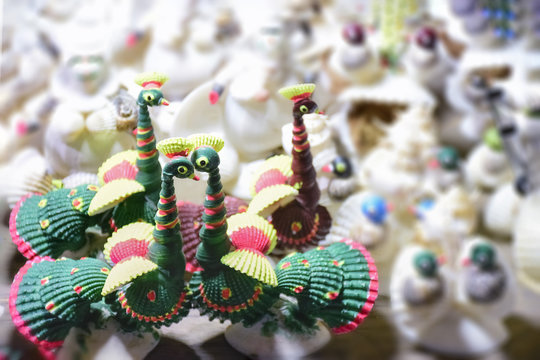 Sea Shell made decorating material selling on the market. Arranged on a row, in line.