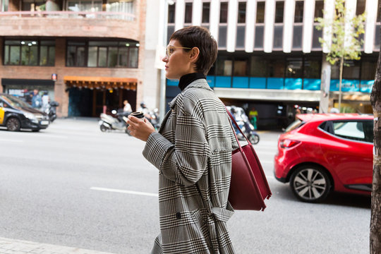 Stylish short haired business woman commuting between meetings on a busy city