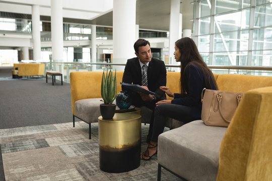 Businesspeople discussing in the lobby