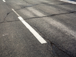 White dashed marking line on the old road