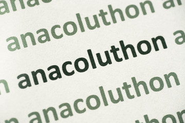 word anacoluthon printed on paper macro