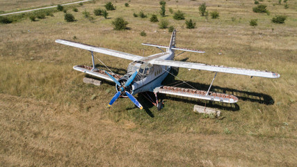 Old abandoned airplane on the field. Top view