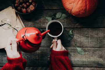 autumn coffee time still life with nuts, pumpkin, book, rose, glasses and a book