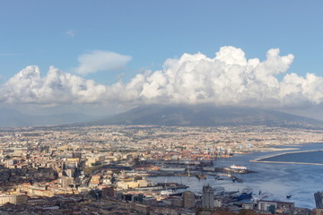 Obraz premium Naples and port of Mediterranean sea and volcano Vesuvius top view. Naples cityscape. Volcano Vesuvius in clouds. Volcano and sea landscape. Travel concept. Aerial italian landscape. Neapol panorama. 