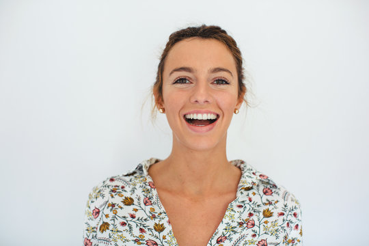 Portrait of a young smiling woman over white background.