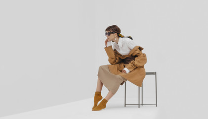 Trendy female / fashion model in abstract white space.