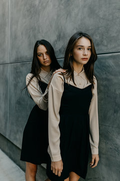 Two Women in Matching Outfits Posing Stoicly