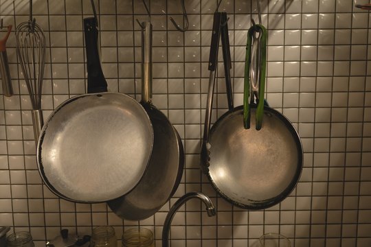 Various cooking pan hung on a wall