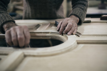 Close up shot of old master carpenter working in his woodwork or workshop