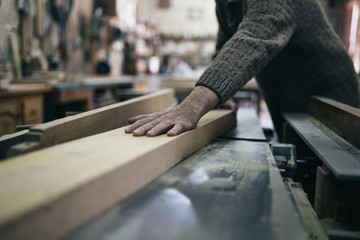 Close up shot of old master carpenter working in his woodwork or workshop