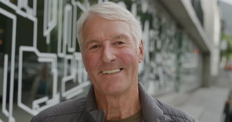portrait of cheerful middle aged caucasian man smiling happy looking at camera enjoying relaxed retirement confident satisfaction city street background - Powered by Adobe