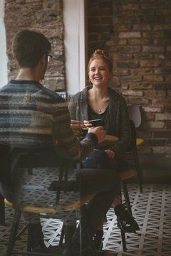 Couple Chatting Over Coffee In The Cafe