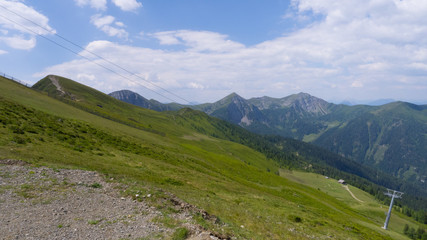 Fototapeta premium hiking path on sloped hills with a view on mountain ridges