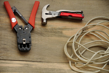 Crimping for a power wire, coil and a coil of wire on a wooden background