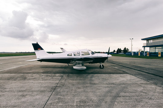 Small Private Airplane Standing on Airfield