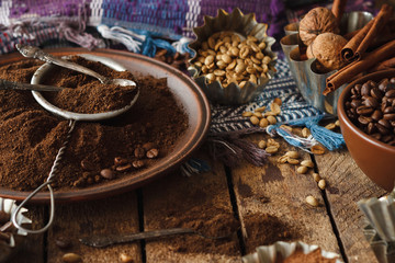 Roasted black and green coffee beans and ground coffee in the plate