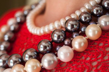 Strings of beads on the red blouse.