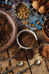 Roasted black and green coffee beans and ground coffee in the plate