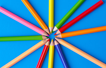  Color pencils on a blue background.