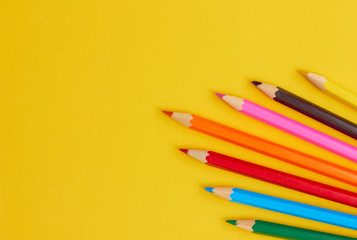  Colored pencils on a yellow background.