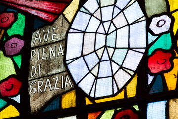 Pavia, Italy. 2018/2/13. Stained glass in a church with the words: 'Ave piena di grazia' meaning...
