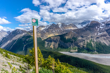 End of hiking trail warning sign in the Canadian Rockies