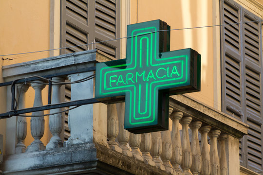 Pavia, Italy. 2018/2/13. A pharmacy sign -  a green cross - above a pharmacy in Italy.