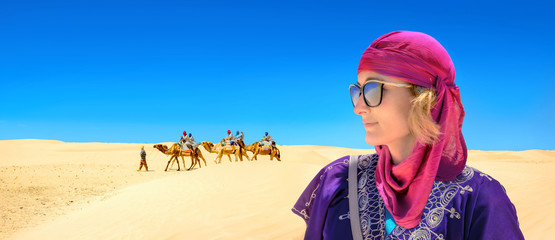 Close-up portrait of young woman in arabic traditional clothing. Sahara desert. Tunisia, North...