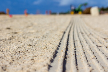 Fototapeta na wymiar Traces of work on the sand