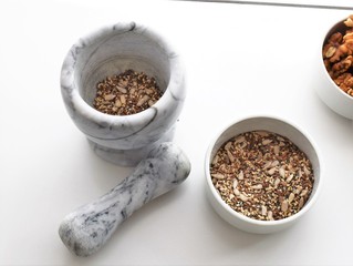 Mixture of sunflower, sesame and chia seeds in a marble morter