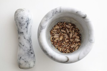 Mixture of sunflower, sesame and chia seeds in a marble morter
